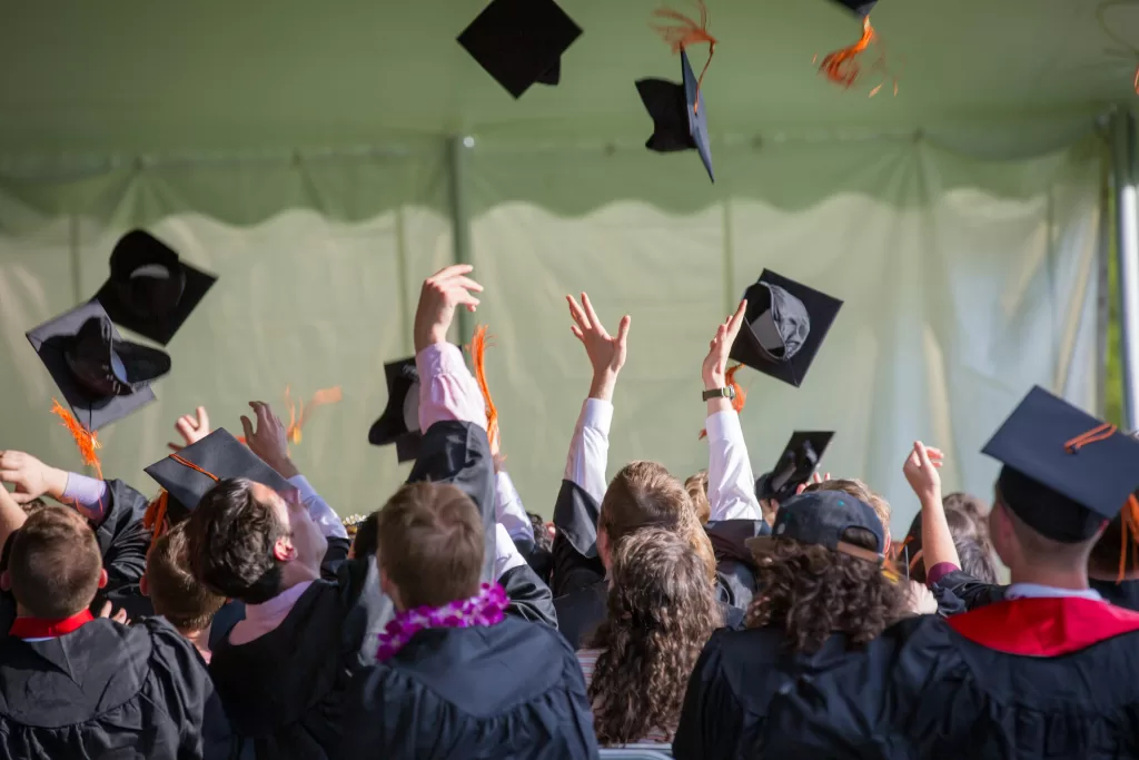 Graduates celebrating with their hats in the air, symbolizing success and career milestones.
